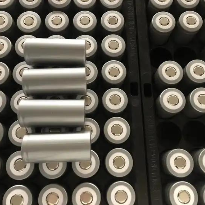 numerous silver cylindrical lithium-ion batteries organized in a black tray.
