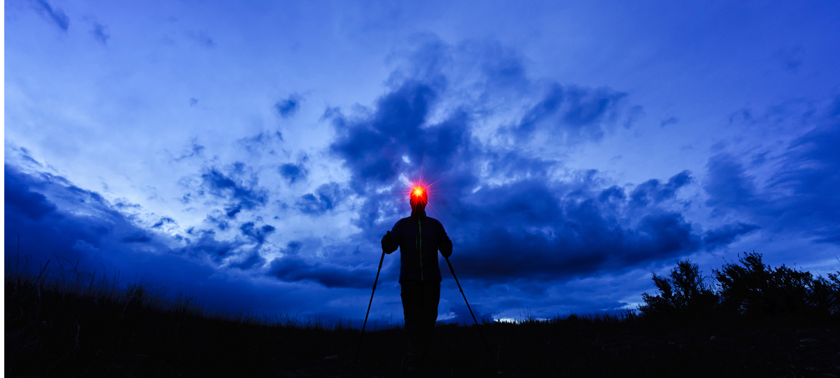 A man using a headlamp to go tracking at night.