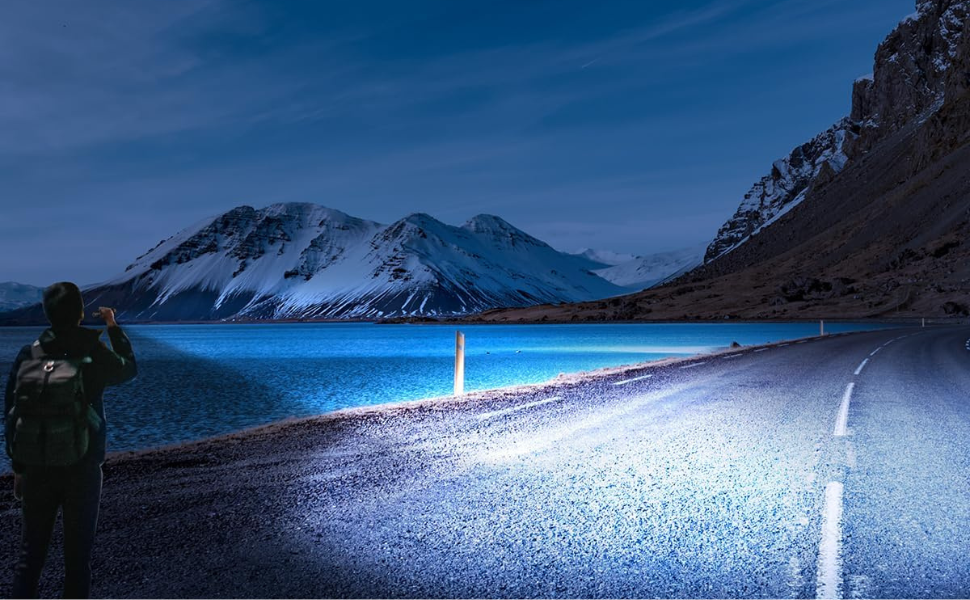 A man uses a flashlight to illuminate the path